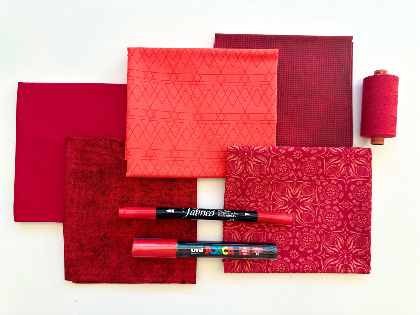 Red rainbow stash builder bundles of quilting fabric in fat quarters with a Posca pen and Fabrico pen and rasant thread available at 2 sew textiles art quilt supplies