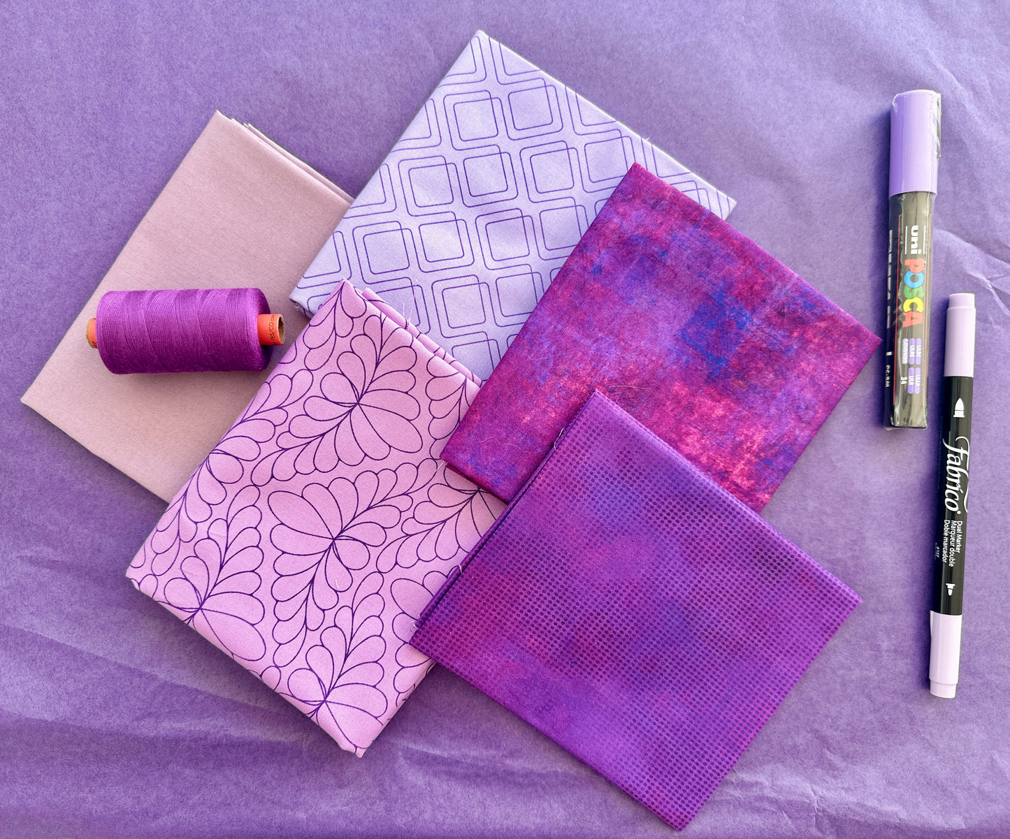 Purple mauve rainbow stash builder bundles of quilting fabric in fat quarters with a Posca pen and Fabrico pen and rasant thread available at 2 sew textiles art quilt supplies