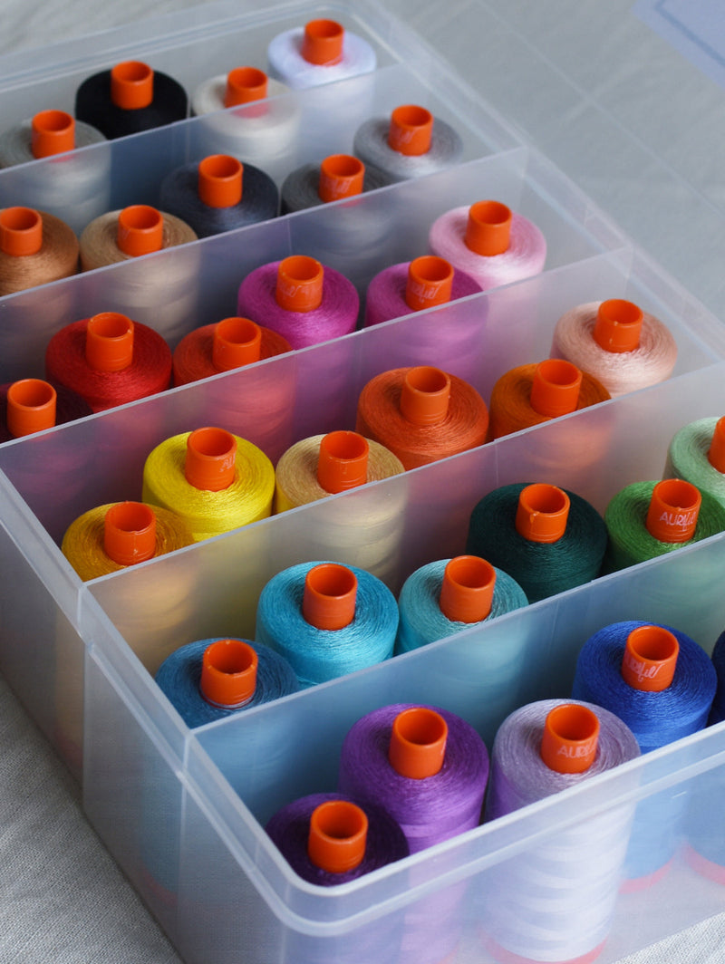 Colorful spools of thread in a clear plastic organizer